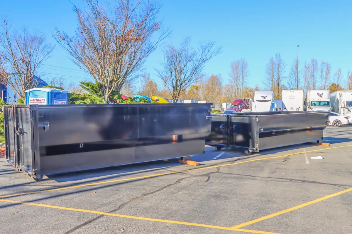 Professional dumpster rental service with roll-off container on residential driveway in Erie